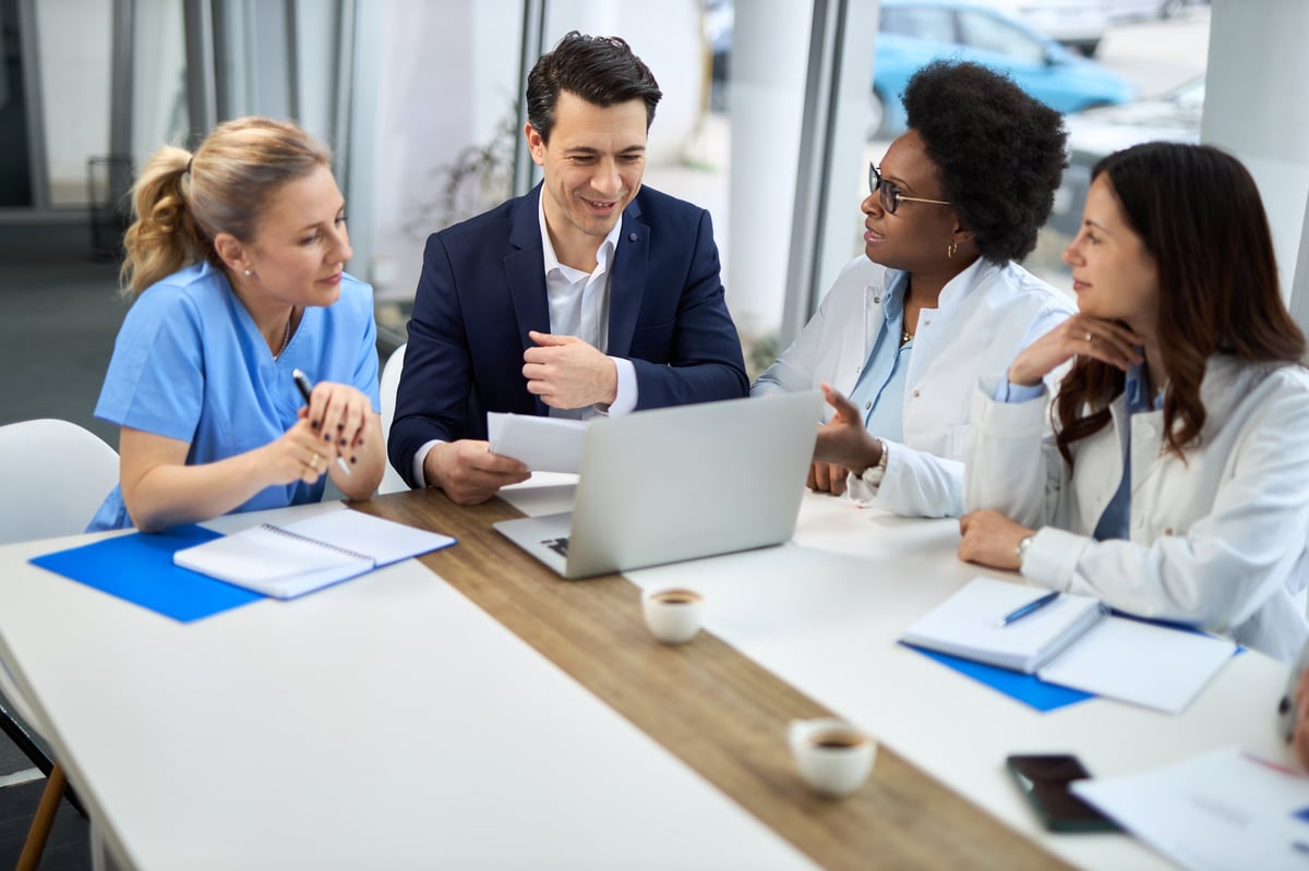 Profesionales de la salud trabajando frente a una computadora en un consultorio moderno